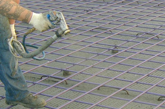 Bonding agent being applied to a reinforced construction surface