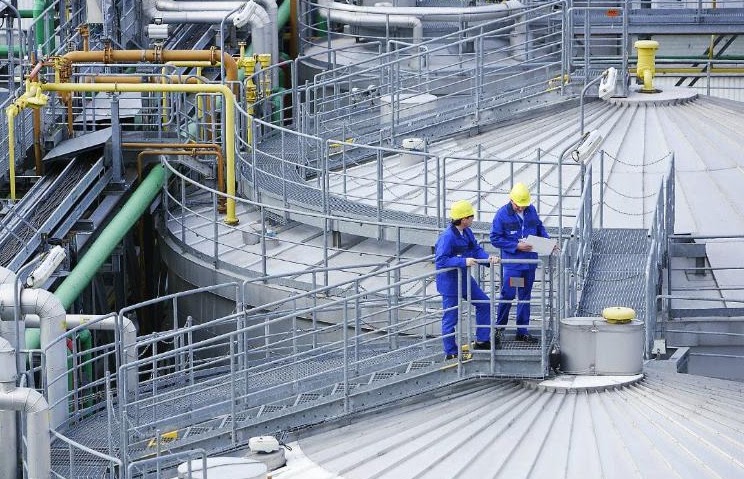Workers at an industrial processing facility