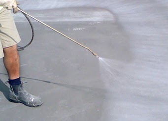 A construction surface receiving spray treatment